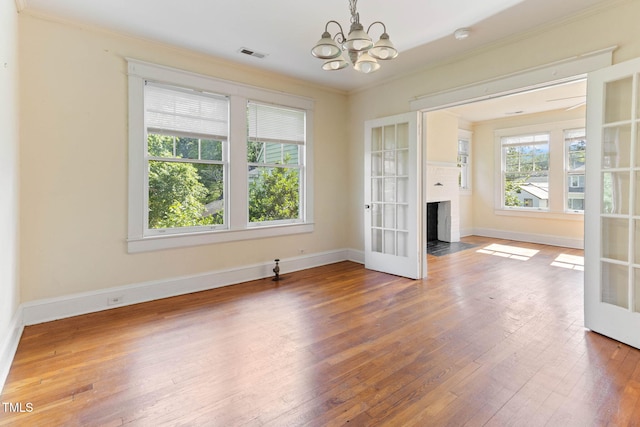 1308-10 Wake Forest Rd, Raleigh, NC 27604 - unfurnished room with ornamental molding, a chandelier, wood-type flooring, french doors, and baseboards