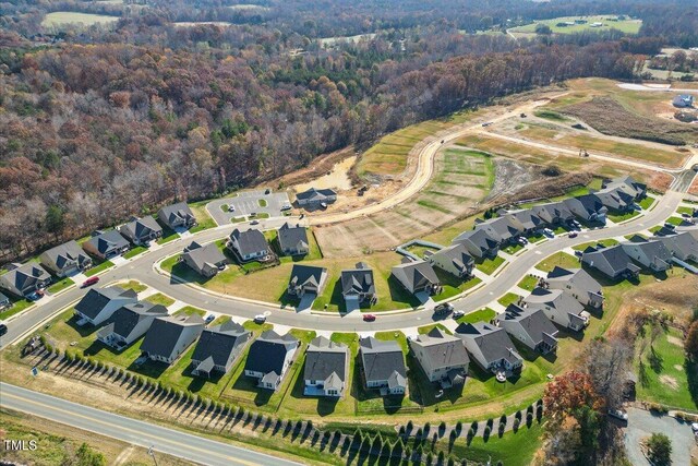 birds eye view of property featuring a residential view and a view of trees