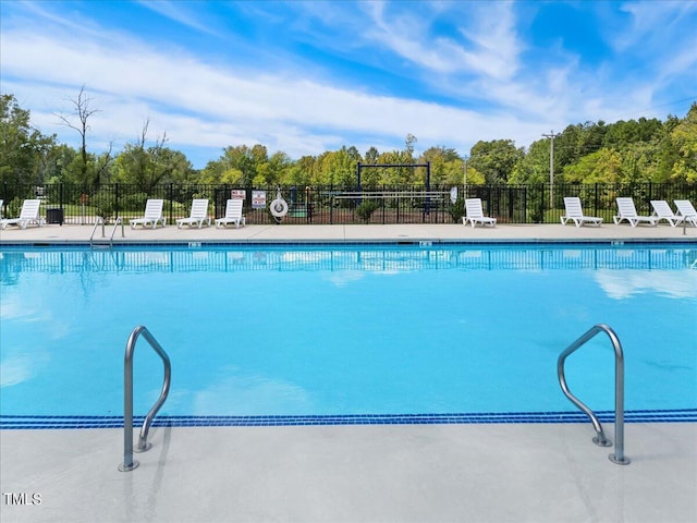 community pool featuring fence