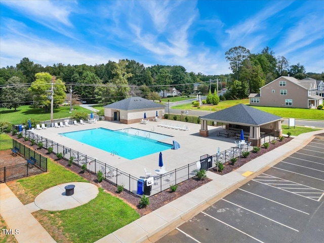 community pool featuring fence, a yard, a patio, and a gazebo