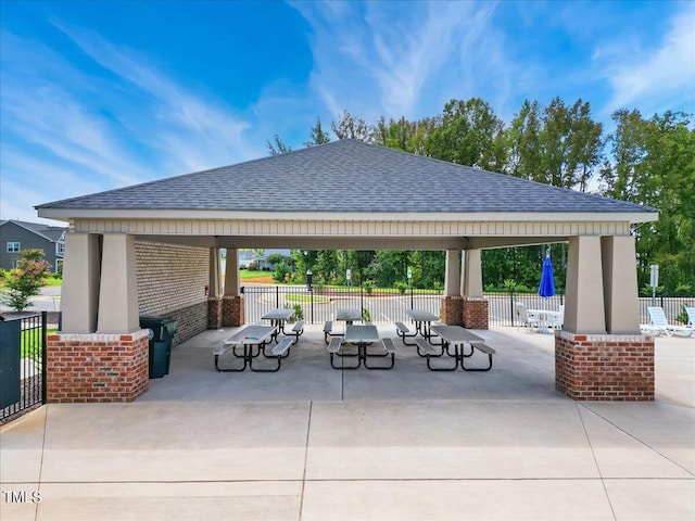 view of community with fence, a patio area, and a gazebo