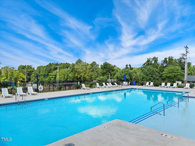 pool with fence and a patio area