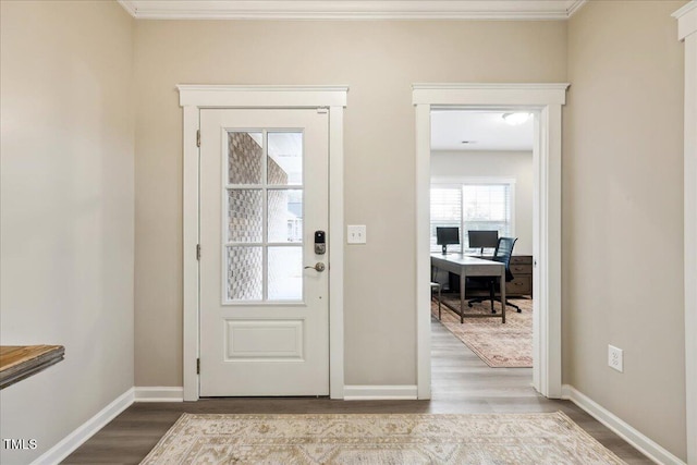 doorway featuring baseboards, wood finished floors, and ornamental molding