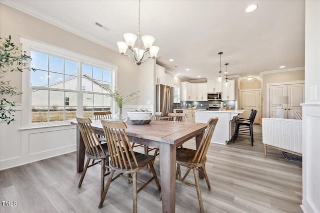 dining space with a chandelier, recessed lighting, visible vents, and crown molding