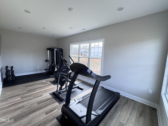 workout room featuring baseboards and wood finished floors