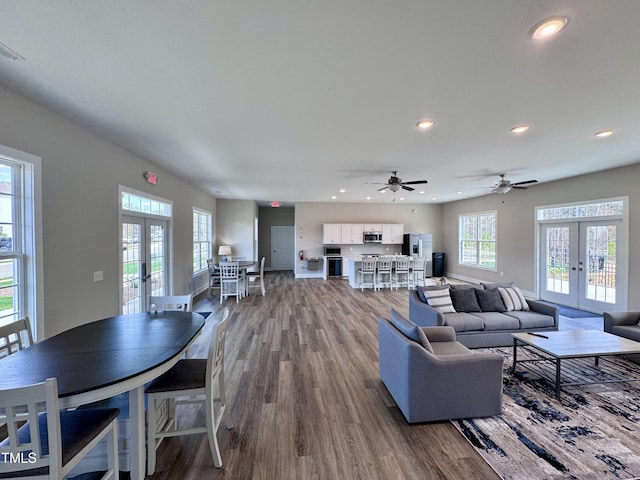 living area featuring wood finished floors, french doors, ceiling fan, and recessed lighting
