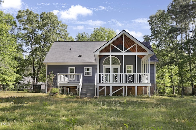 back of property featuring fence and a wooden deck