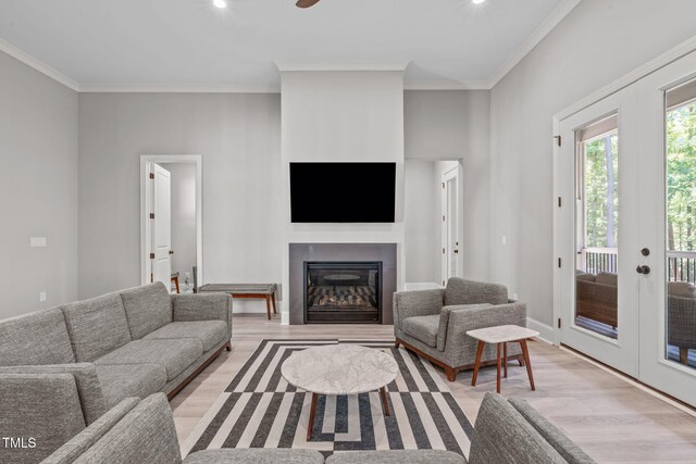 59 Mill Rd, Pittsboro, NC 27312 - living room with light wood-type flooring, ornamental molding, a glass covered fireplace, and french doors