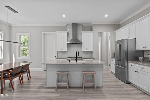 59 Mill Rd, Pittsboro, NC 27312 - kitchen with wall chimney range hood, tasteful backsplash, light stone countertops, a kitchen bar, and white cabinetry