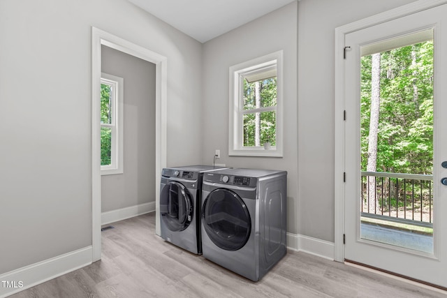59 Mill Rd, Pittsboro, NC 27312 - laundry room featuring washer and clothes dryer, light wood-style floors, baseboards, and healthy amount of natural light