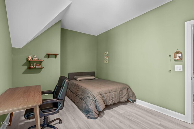 59 Mill Rd, Pittsboro, NC 27312 - bedroom with wood finished floors, baseboards, an office area, and vaulted ceiling