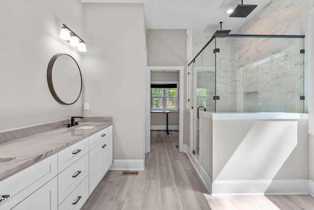 59 Mill Rd, Pittsboro, NC 27312 - full bathroom featuring a marble finish shower, double vanity, wood finished floors, and baseboards