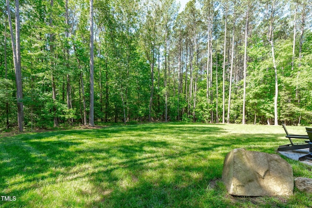 59 Mill Rd, Pittsboro, NC 27312 - view of green lawn featuring a forest view