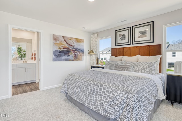 1167 Abbott St, Mebane, NC 27302 - carpeted bedroom featuring baseboards and connected bathroom