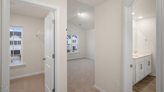 412 Ember St, Sanford, NC 27330 - hallway with a sink, baseboards, carpet flooring, and lofted ceiling