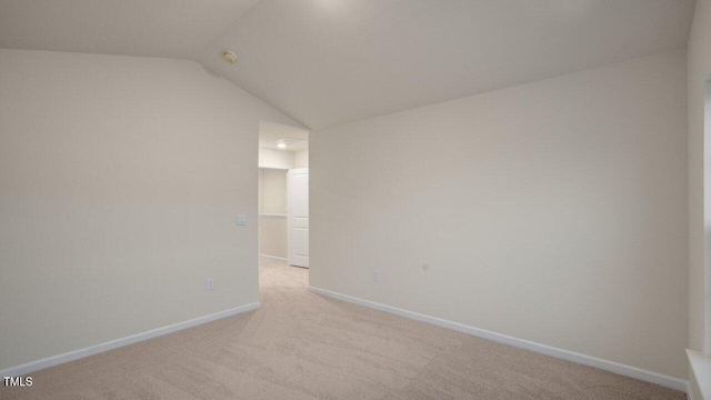 412 Ember St, Sanford, NC 27330 - empty room with baseboards, light colored carpet, and vaulted ceiling