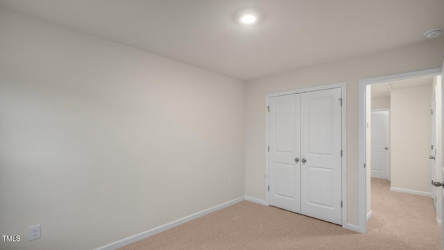 412 Ember St, Sanford, NC 27330 - unfurnished bedroom with baseboards, a closet, and light carpet