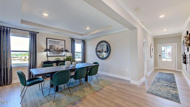 2625 Stonington Dr, Cary, NC 27523 - dining area with baseboards, a raised ceiling, light wood finished floors, ornamental molding, and recessed lighting