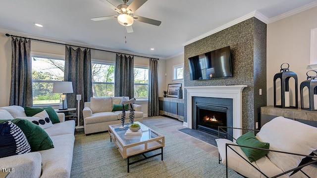2625 Stonington Dr, Cary, NC 27523 - living room featuring ceiling fan, a fireplace with flush hearth, wood finished floors, ornamental molding, and recessed lighting