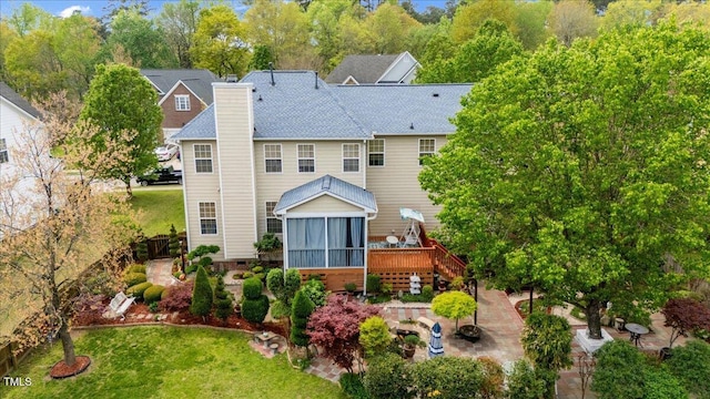 1012 Delta River Way, Knightdale, NC 27545 - rear view of house featuring a sunroom, a chimney, stairway, and a yard