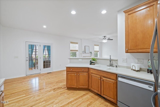1012 Delta River Way, Knightdale, NC 27545 - kitchen with a sink, white dishwasher, a peninsula, a ceiling fan, and light wood-style floors