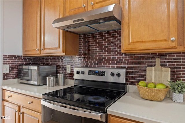 1012 Delta River Way, Knightdale, NC 27545 - kitchen featuring stainless steel electric range oven, under cabinet range hood, decorative backsplash, and light countertops