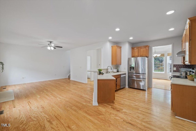 1012 Delta River Way, Knightdale, NC 27545 - kitchen with stainless steel appliances, a peninsula, light wood-style floors, light countertops, and recessed lighting