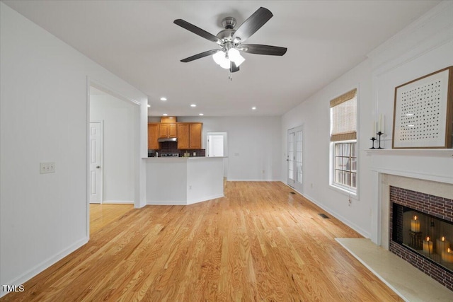 1012 Delta River Way, Knightdale, NC 27545 - unfurnished living room featuring a fireplace, baseboards, ceiling fan, light wood-type flooring, and recessed lighting