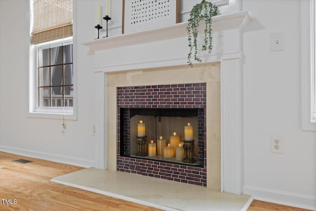 1012 Delta River Way, Knightdale, NC 27545 - detailed view of a tiled fireplace, wood finished floors, and baseboards