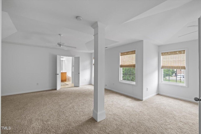 1012 Delta River Way, Knightdale, NC 27545 - unfurnished living room featuring carpet, vaulted ceiling, a ceiling fan, baseboards, and ornate columns