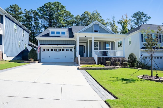 1013 Chelsea Run Ln, Apex, NC 27502 - view of front of house with board and batten siding, a porch, driveway, a front lawn, and a garage
