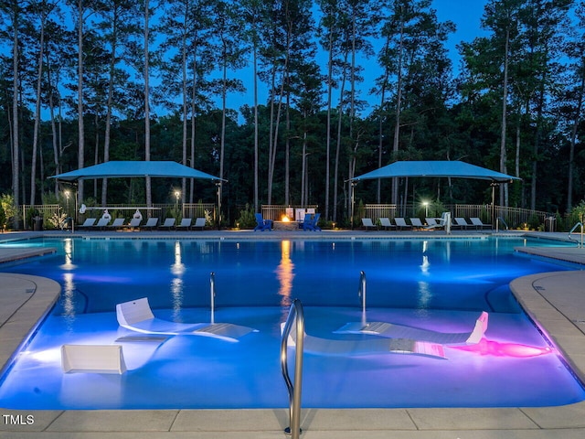 community pool with fence and a patio