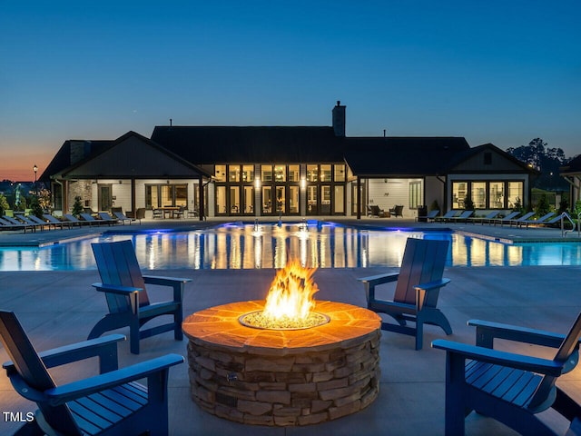 pool featuring a patio, a fire pit, and french doors