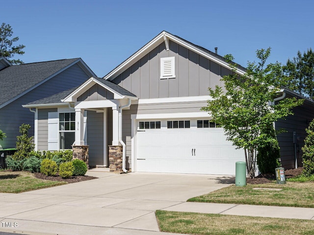 craftsman-style house with an attached garage, board and batten siding, concrete driveway, and stone siding