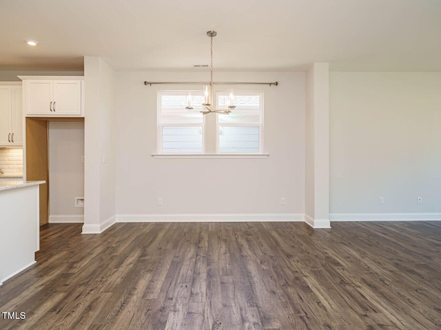 unfurnished dining area featuring an inviting chandelier, recessed lighting, baseboards, and dark wood-type flooring