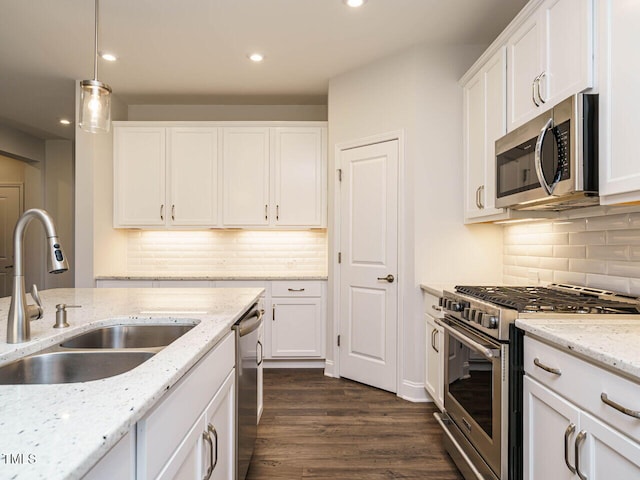 kitchen featuring recessed lighting, a sink, appliances with stainless steel finishes, and white cabinets