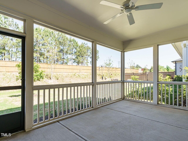 unfurnished sunroom featuring ceiling fan