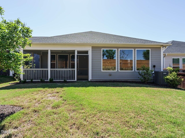 back of house featuring a sunroom, central AC unit, and a yard