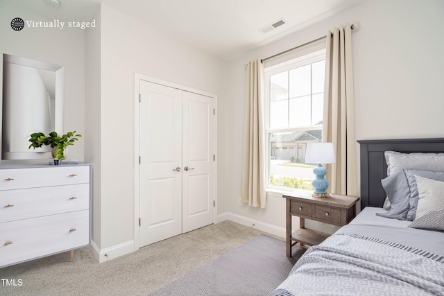 bedroom with visible vents, baseboards, carpet floors, and a closet