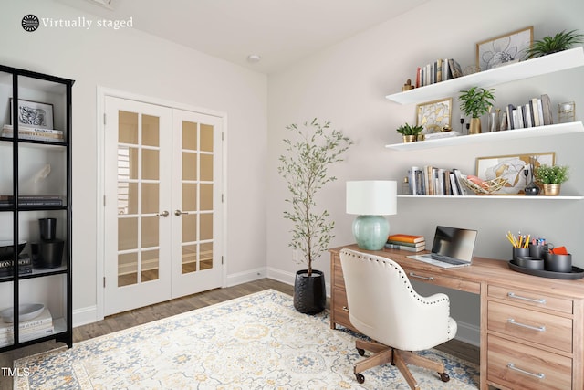 office space featuring built in desk, baseboards, french doors, and wood finished floors