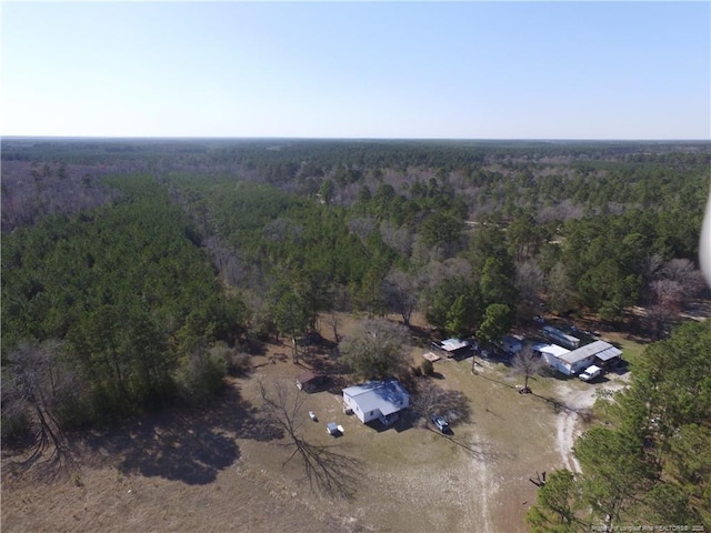 birds eye view of property with a wooded view