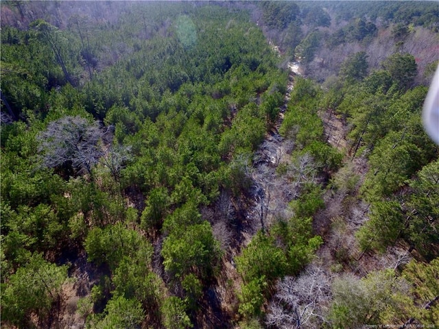 birds eye view of property featuring a view of trees