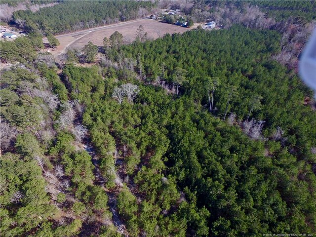 birds eye view of property with a view of trees
