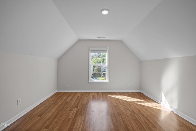 bonus room featuring baseboards, visible vents, and wood finished floors