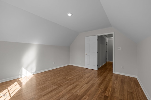 bonus room with baseboards, wood finished floors, and lofted ceiling