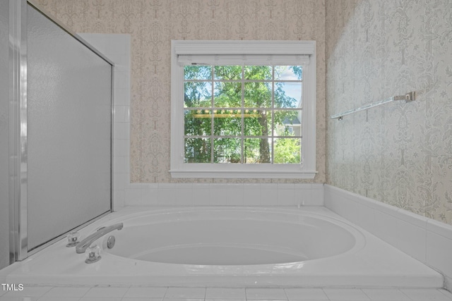 full bath featuring a garden tub and wallpapered walls