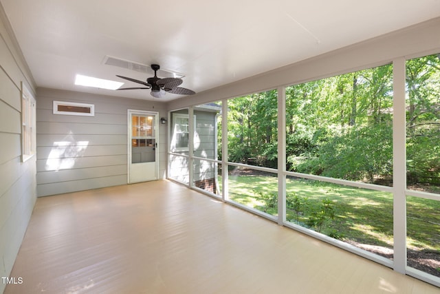 unfurnished sunroom with a skylight and a ceiling fan
