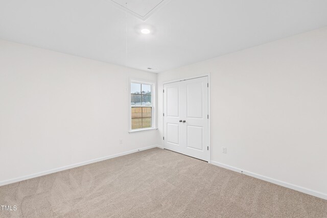 60 Rosewood Ln, Youngsville, NC 27596 - empty room with baseboards, attic access, and carpet floors