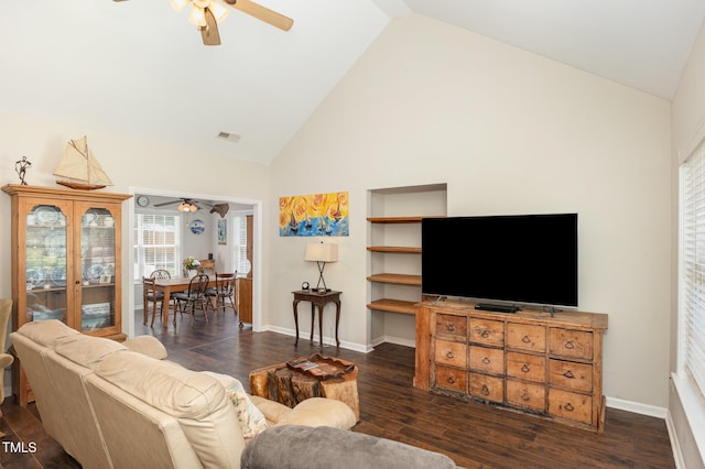 living area featuring high vaulted ceiling, a ceiling fan, and dark wood-type flooring