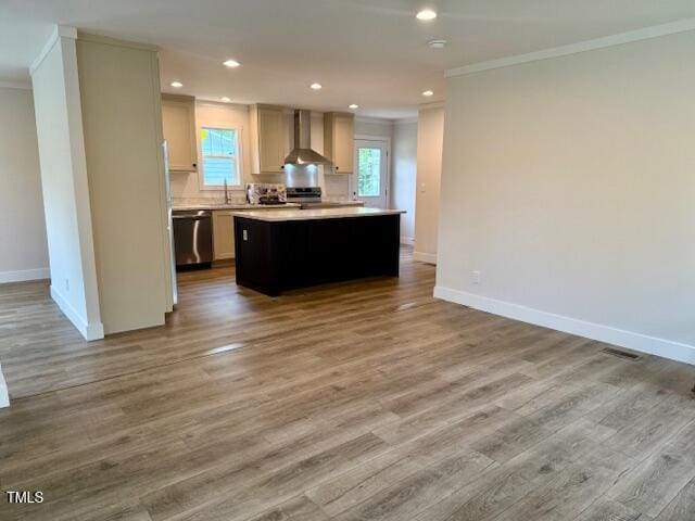 kitchen with wall chimney range hood, stainless steel dishwasher, light countertops, baseboards, and ornamental molding